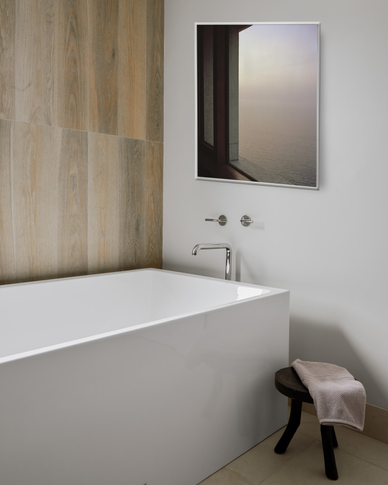 Medium sized modern ensuite bathroom in Los Angeles with flat-panel cabinets, beige cabinets, a freestanding bath, a corner shower, multi-coloured walls, limestone flooring, engineered stone worktops, beige floors, a hinged door, white worktops, double sinks and a floating vanity unit.