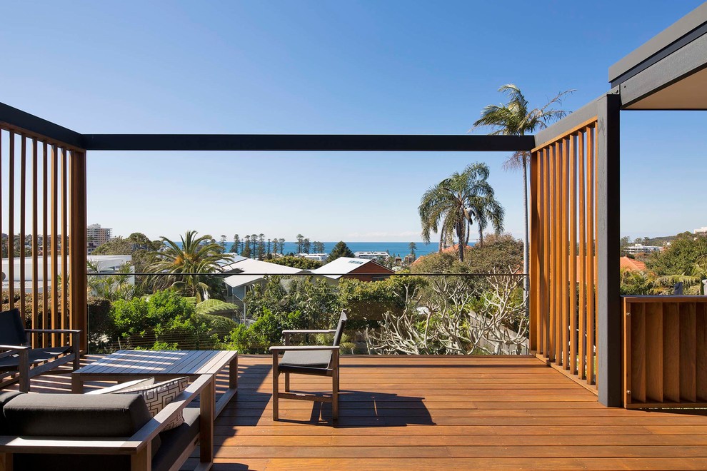 Large contemporary deck in Sydney with an awning.