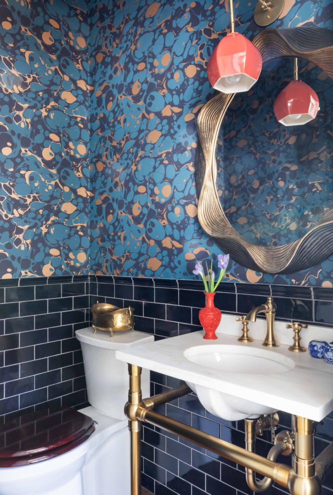 Powder room - transitional blue tile and subway tile wallpaper powder room idea in Chicago with a two-piece toilet, multicolored walls, an undermount sink and white countertops