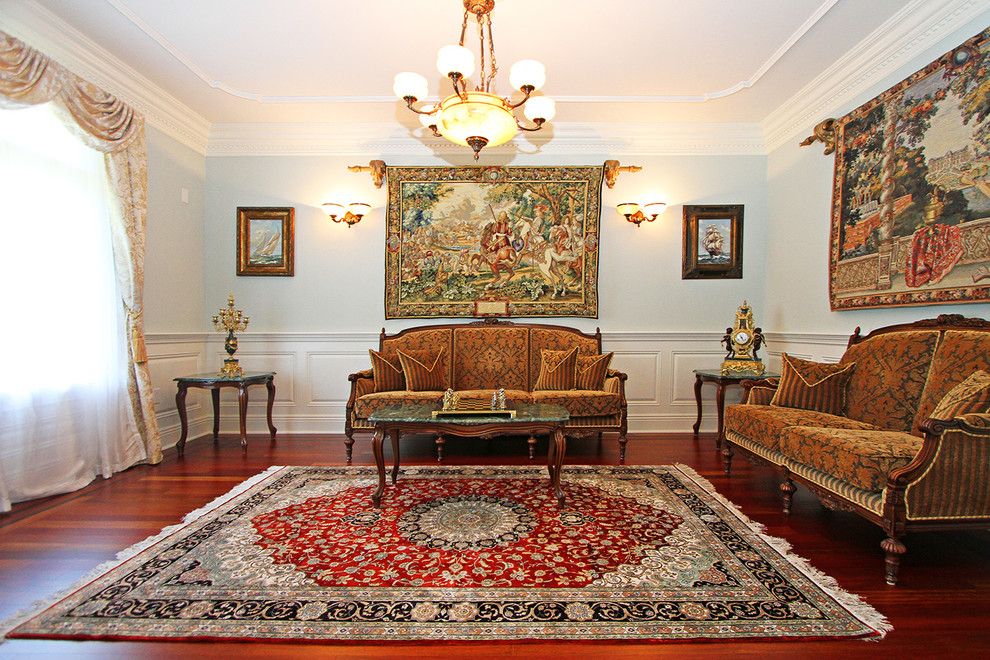 This is an example of a mid-sized traditional formal enclosed living room in New York with blue walls, dark hardwood floors, no fireplace and no tv.