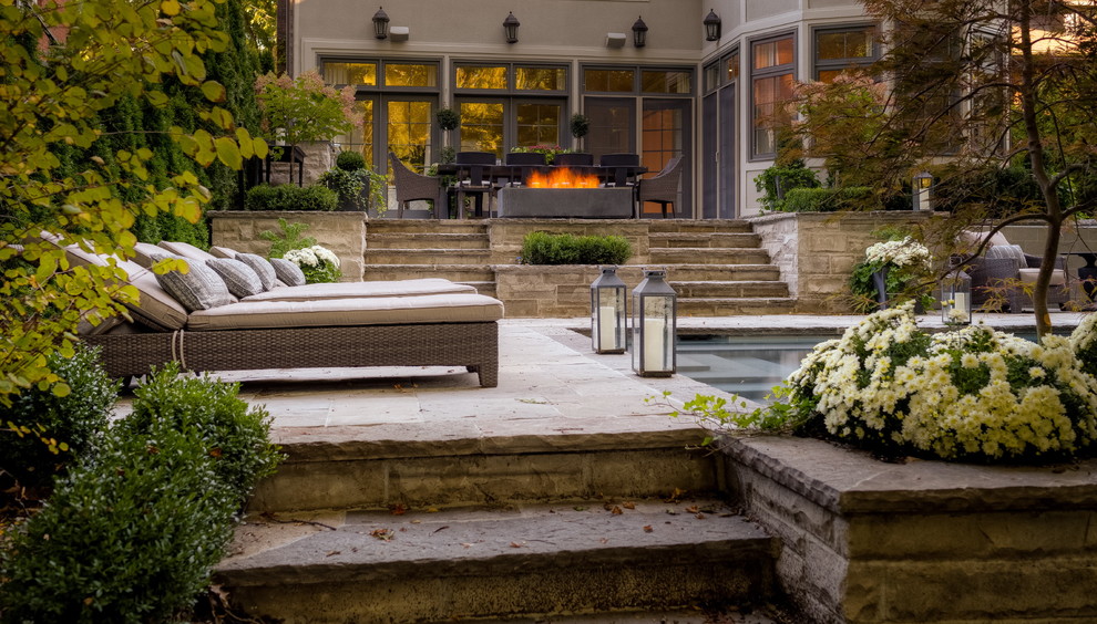 Inspiration for a traditional patio in Toronto with a fire feature.