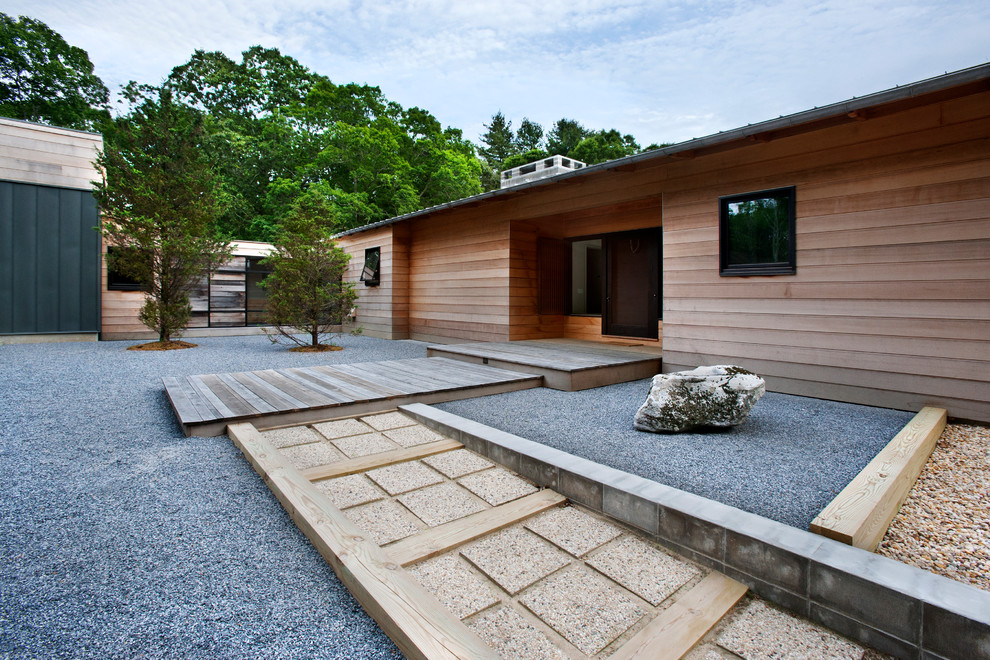 This is an example of a contemporary xeriscape in New York with a garden path and decking.