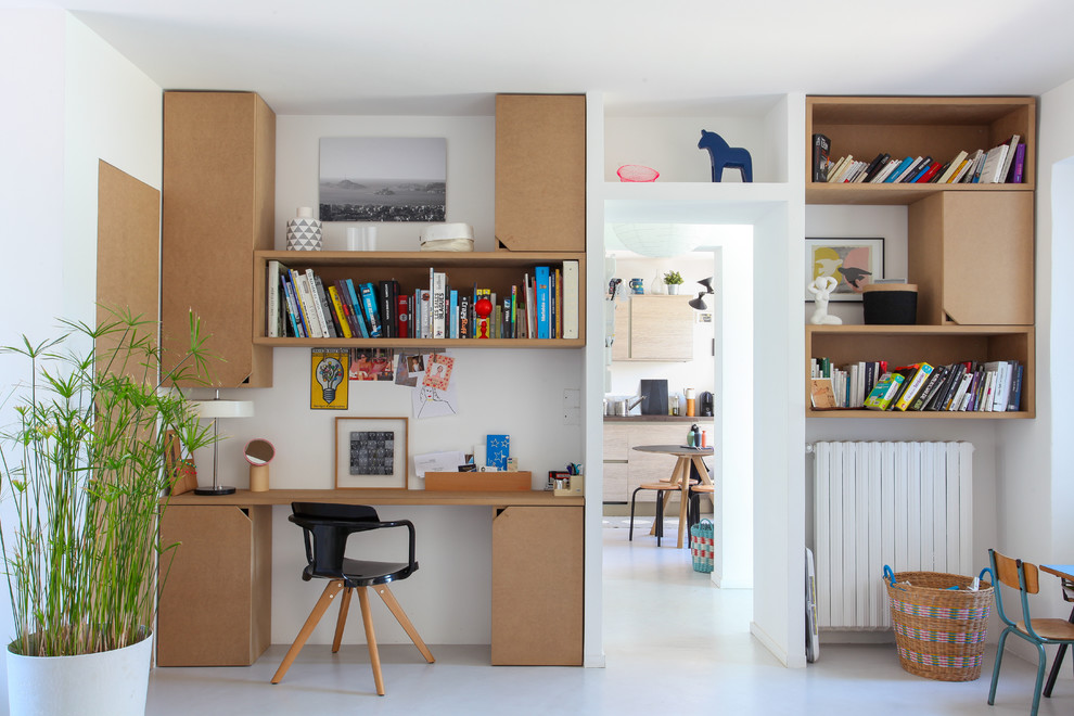 This is an example of a mid-sized scandinavian study room in Marseille with white walls, no fireplace and a built-in desk.