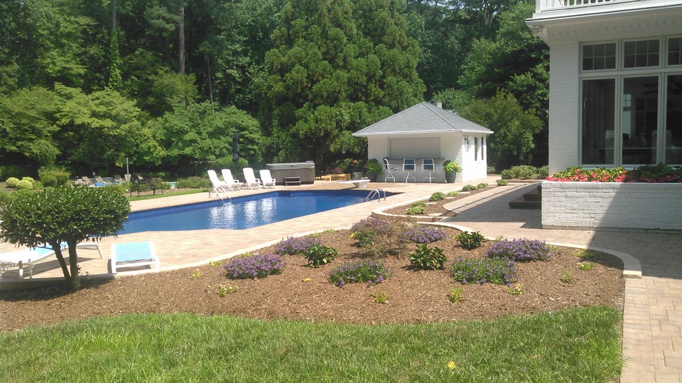 Example of a mid-sized trendy backyard concrete paver pool design