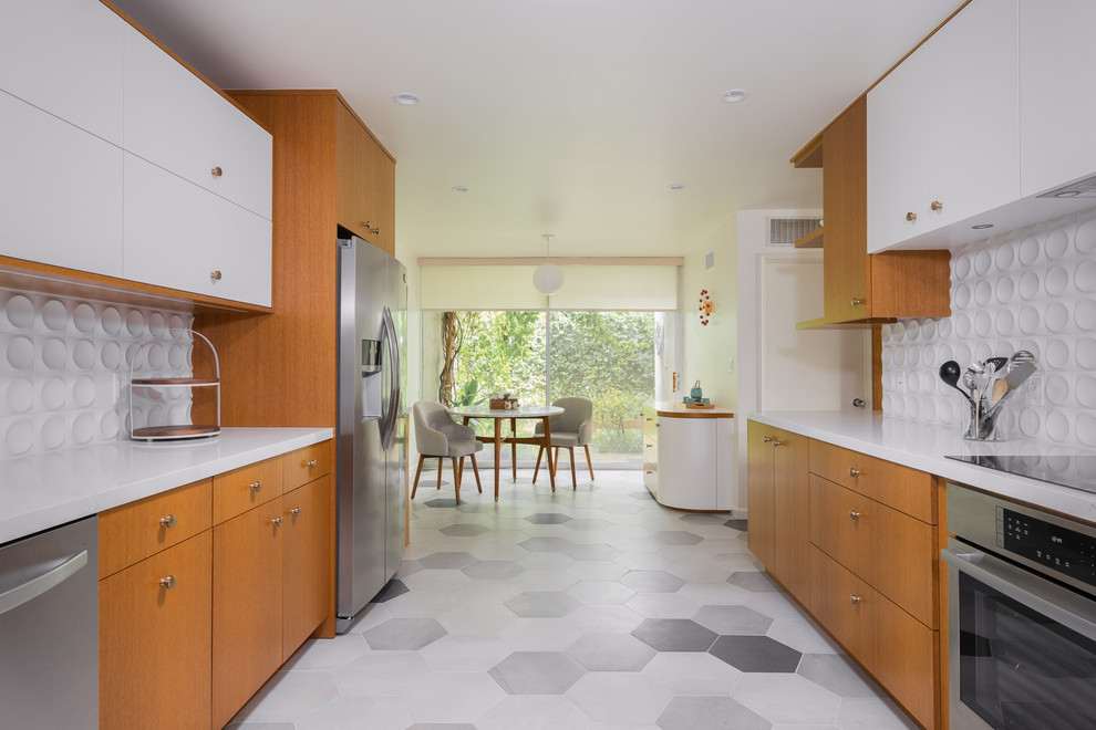 Photo of a mid-sized contemporary l-shaped separate kitchen in Los Angeles with an undermount sink, flat-panel cabinets, medium wood cabinets, quartz benchtops, white splashback, porcelain splashback, stainless steel appliances, porcelain floors, a peninsula, multi-coloured floor and white benchtop.