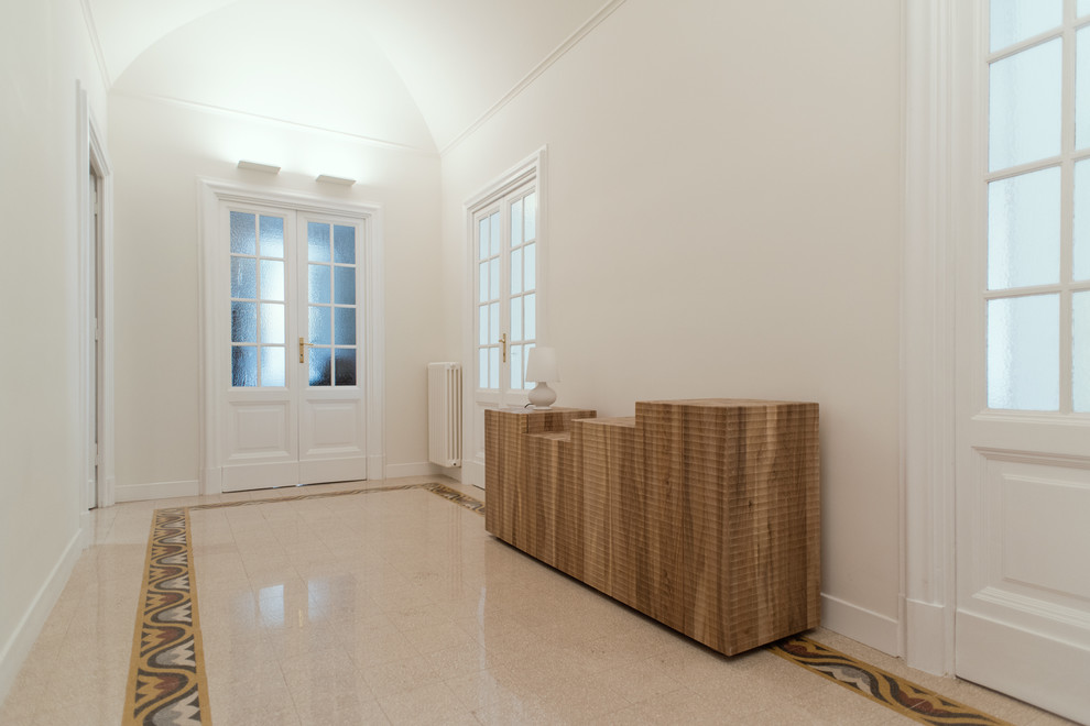 Large contemporary foyer in Rome with white walls, terrazzo floors, a double front door, beige floor and vaulted.