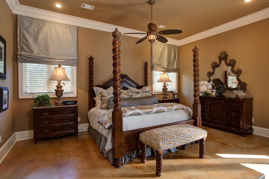 Inspiration for a mid-sized traditional master bedroom in Little Rock with brown walls, concrete floors and brown floor.