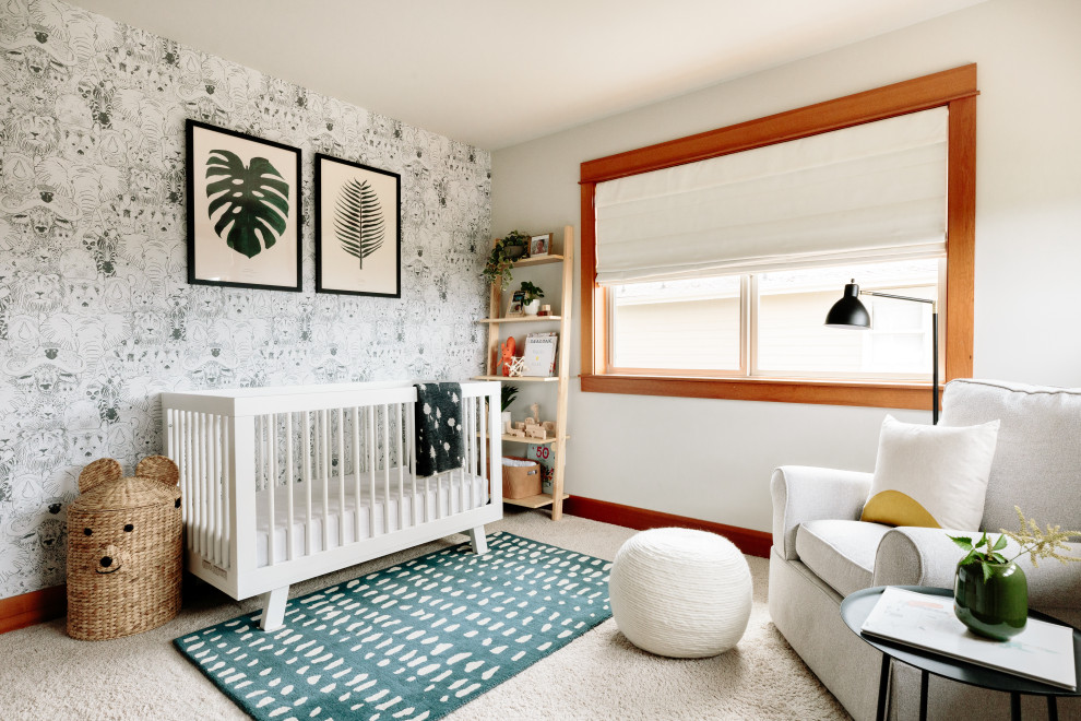 This is an example of a mid-sized modern nursery for boys in Seattle with blue walls, carpet, beige floor and wallpaper.