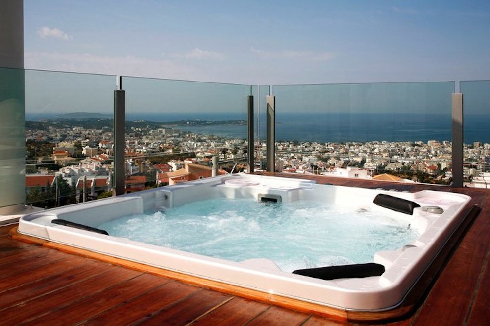 Inspiration for a small rooftop infinity pool in Other with a hot tub.