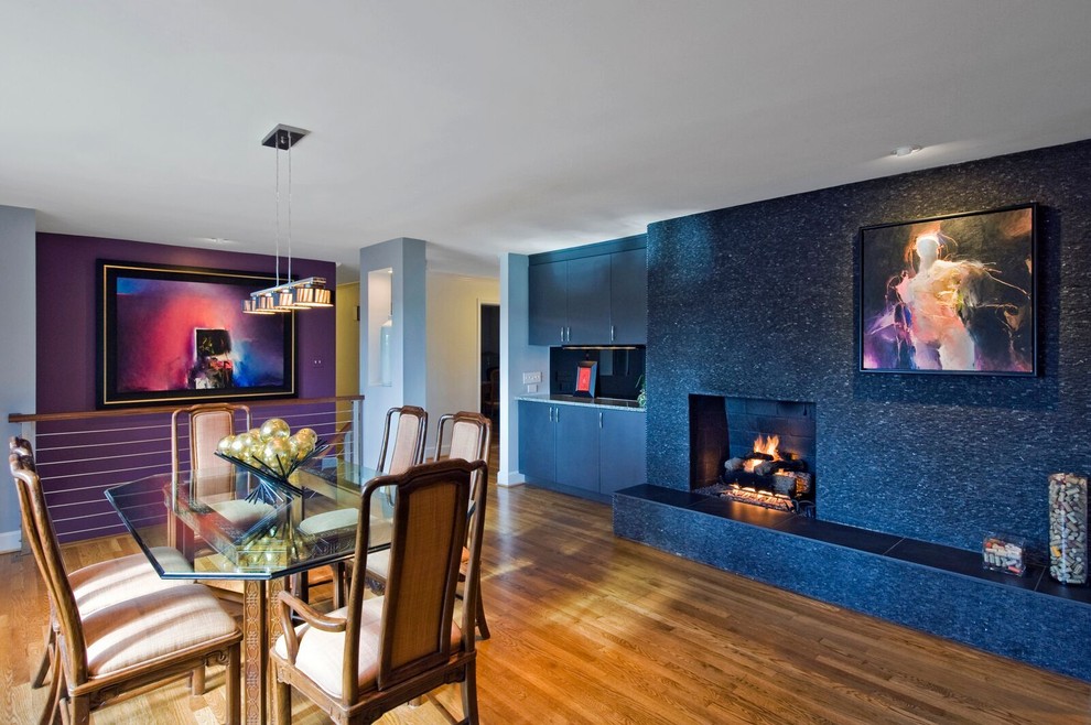 Inspiration for a mid-sized transitional medium tone wood floor and brown floor kitchen/dining room combo remodel in Orange County with blue walls, a standard fireplace and a tile fireplace