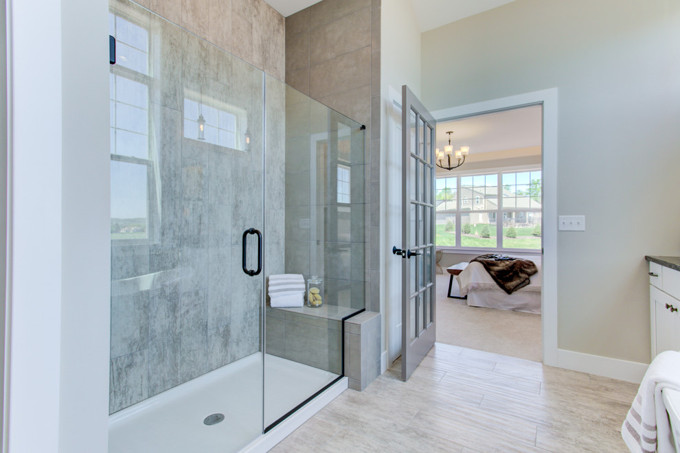 Design ideas for an expansive arts and crafts master bathroom in Other with white cabinets, a freestanding tub, an alcove shower, a two-piece toilet, black tile, beige walls, ceramic floors, an undermount sink, engineered quartz benchtops, a hinged shower door and black benchtops.