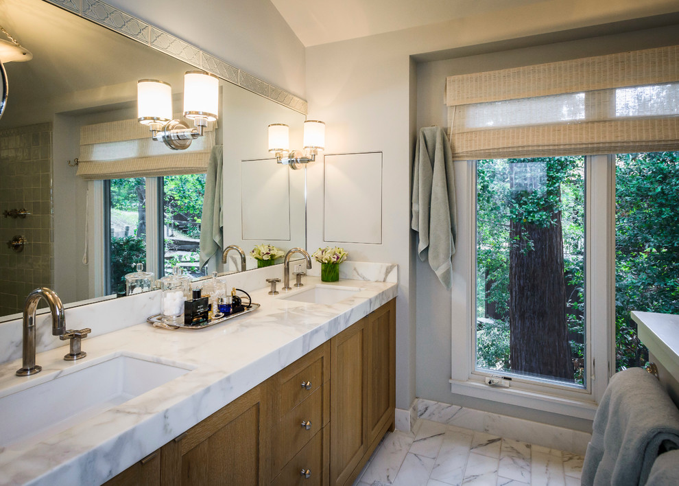 Photo of a large country master bathroom in San Francisco with shaker cabinets, medium wood cabinets, an undermount tub, a curbless shower, grey walls, marble floors, an undermount sink and marble benchtops.