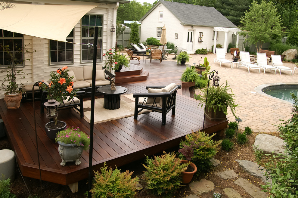 This is an example of a large traditional backyard deck in DC Metro with an awning.