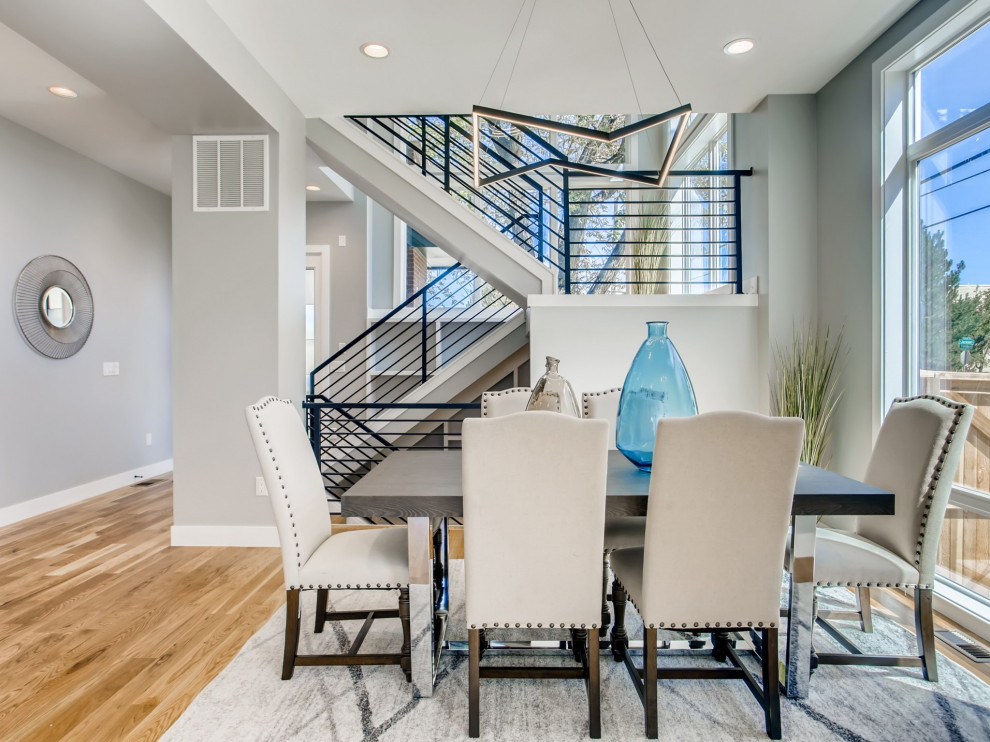 Enclosed dining room - large contemporary light wood floor and brown floor enclosed dining room idea in Denver with gray walls and no fireplace