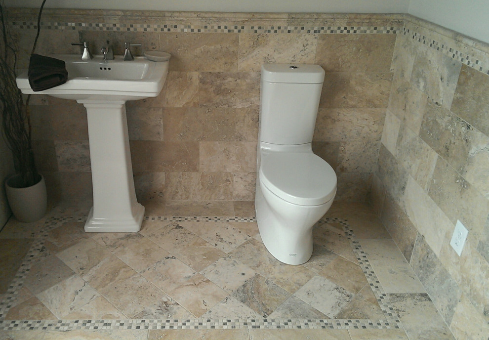 Bathroom - mid-sized transitional brown tile and stone tile travertine floor bathroom idea with a one-piece toilet, gray walls and a pedestal sink