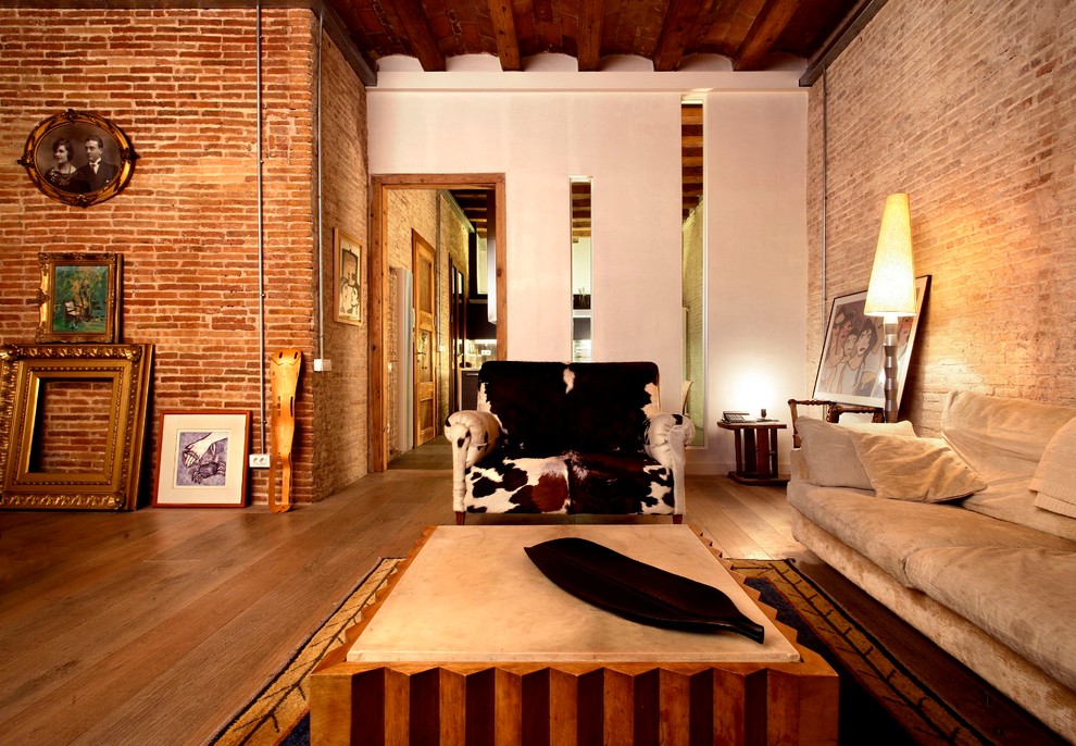 Design ideas for a contemporary living room in Barcelona with orange walls and medium hardwood floors.