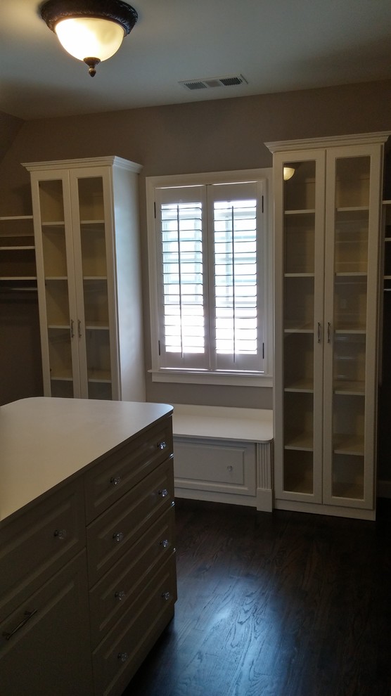 Design ideas for a large traditional women's walk-in wardrobe in Atlanta with raised-panel cabinets, white cabinets and dark hardwood floors.