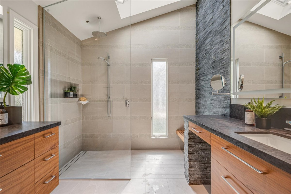 Mid-sized 1960s master gray tile and stone tile vaulted ceiling, porcelain tile, gray floor and double-sink bathroom photo in San Francisco with flat-panel cabinets, medium tone wood cabinets, a one-piece toilet, gray walls, an undermount sink, quartz countertops, gray countertops and a built-in vanity