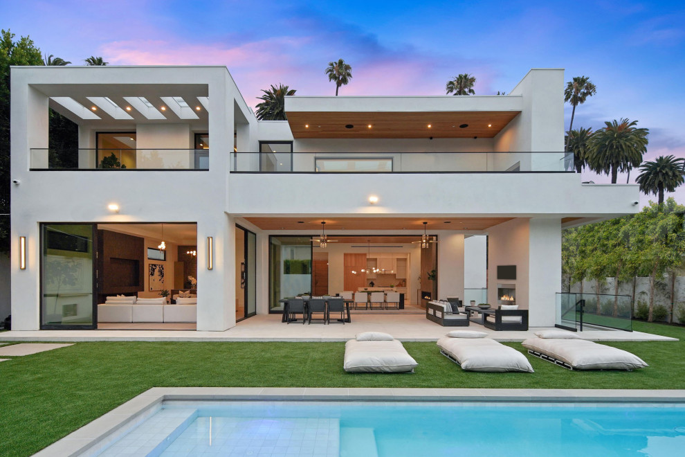 Inspiration for a large modern two-storey stucco white house exterior in Los Angeles with a flat roof.