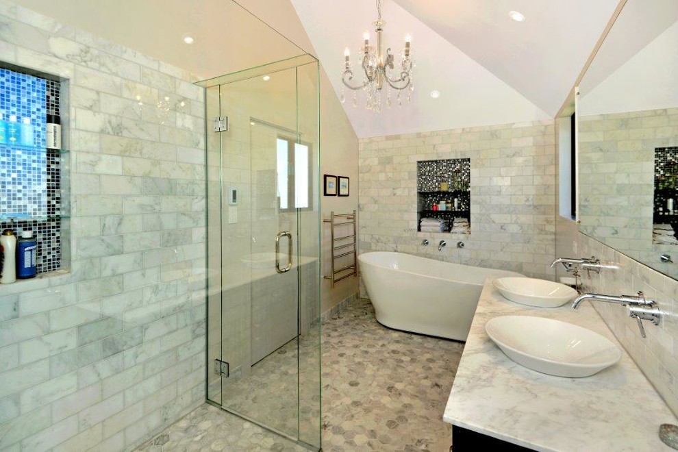 This is an example of a large traditional master bathroom in Auckland with shaker cabinets, brown cabinets, a freestanding tub, a curbless shower, a two-piece toilet, white tile, stone tile, beige walls, marble floors, a vessel sink and marble benchtops.