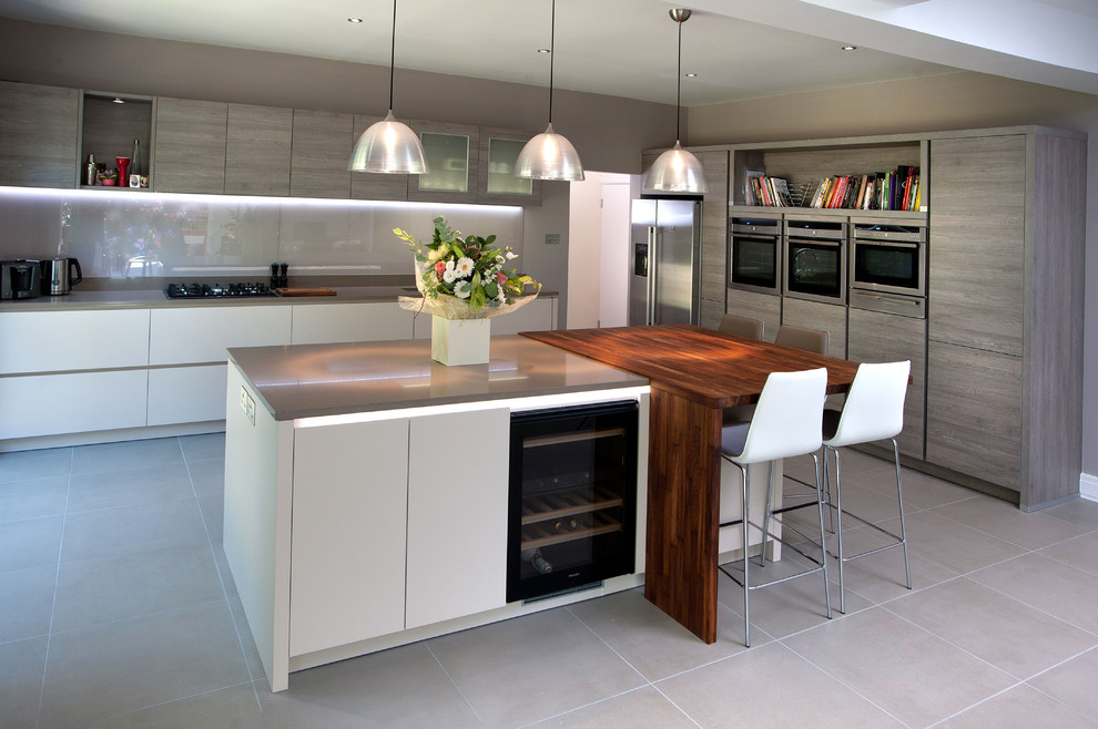 Photo of a large contemporary open plan kitchen in Other with an undermount sink, flat-panel cabinets, quartzite benchtops, glass sheet splashback, stainless steel appliances, porcelain floors and with island.