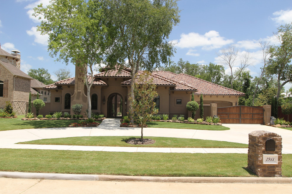 Photo of a large mediterranean one-storey stucco brown exterior in Houston.