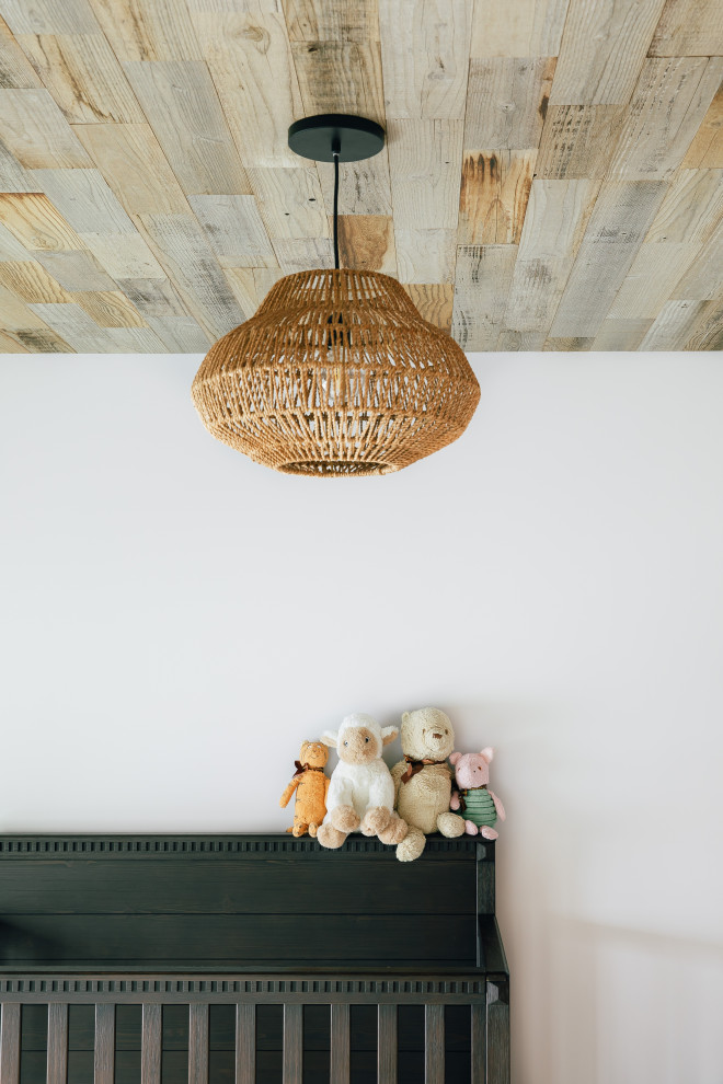 Example of a large beach style boy light wood floor, brown floor and wood ceiling nursery design in Other with white walls