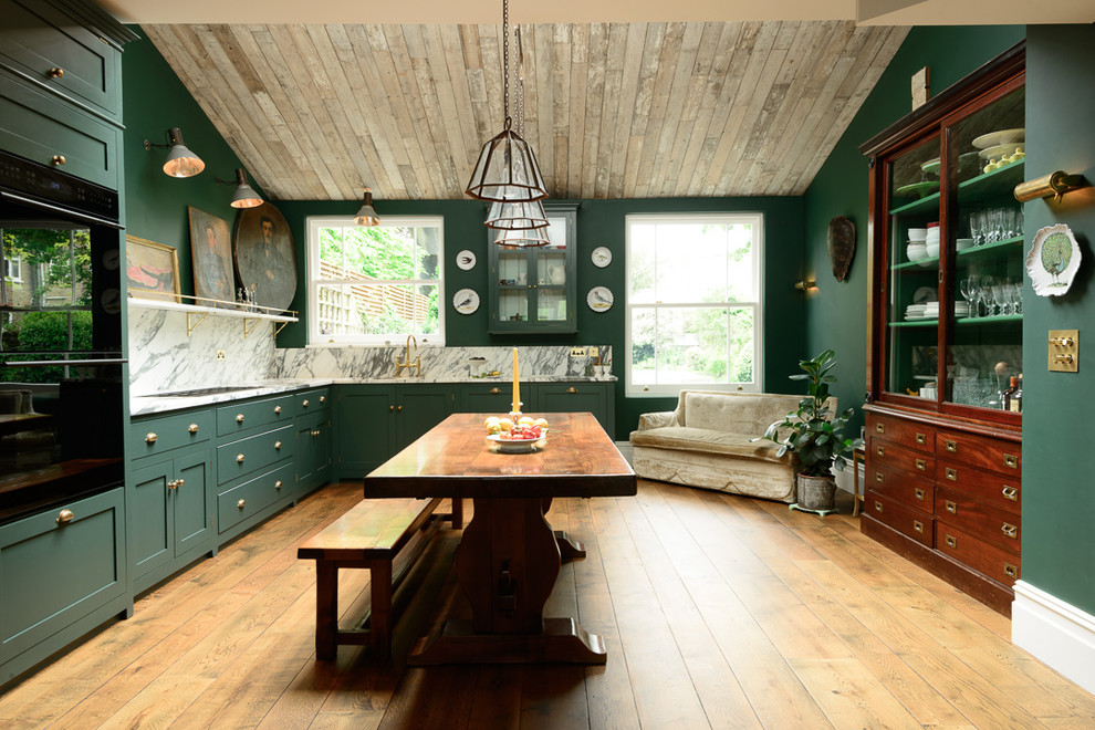 This is an example of a large traditional l-shaped eat-in kitchen in Other with a drop-in sink, green cabinets, marble benchtops, white splashback, black appliances, dark hardwood floors, no island and shaker cabinets.