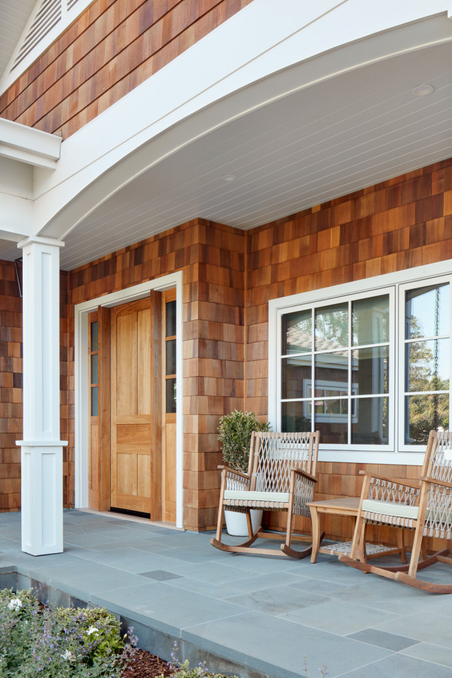 Mid-sized transitional stone front porch idea in San Francisco with a roof extension