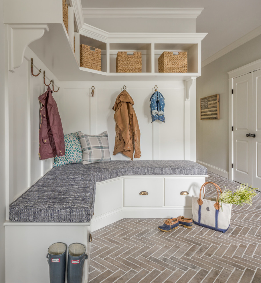 Inspiration for a country mudroom in Boston with grey walls, brick floors and red floor.