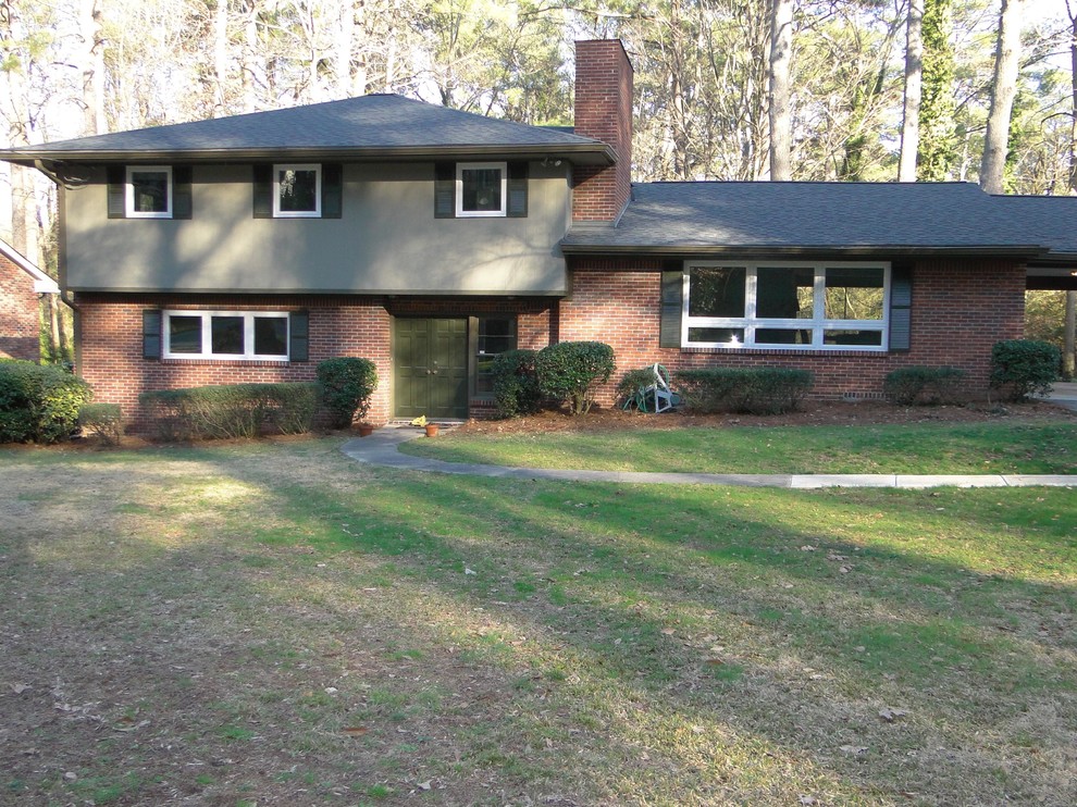 Photo of a large midcentury two-storey multi-coloured exterior in Atlanta with mixed siding and a hip roof.