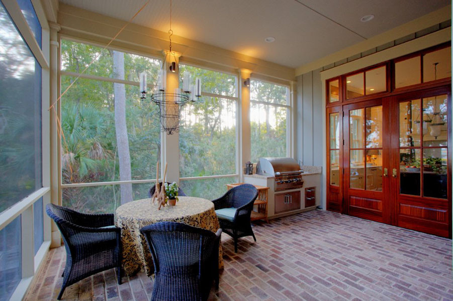 This is an example of a traditional backyard verandah in Atlanta with brick pavers and a roof extension.