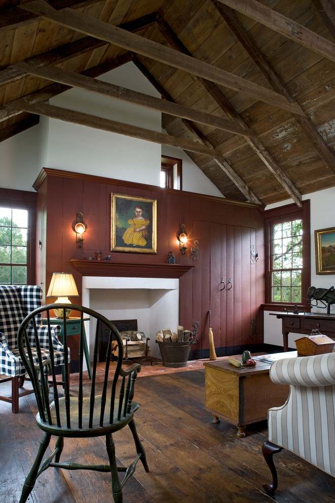 Country living room in Philadelphia with white walls, dark hardwood floors, a standard fireplace and no tv.
