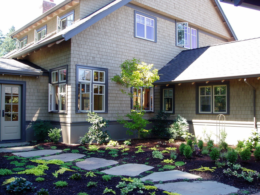Inspiration for a traditional two-storey exterior in Other with wood siding.