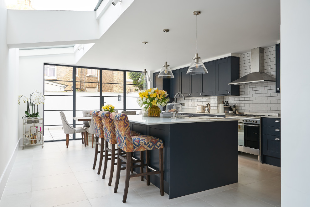 This is an example of a large transitional kitchen in London.