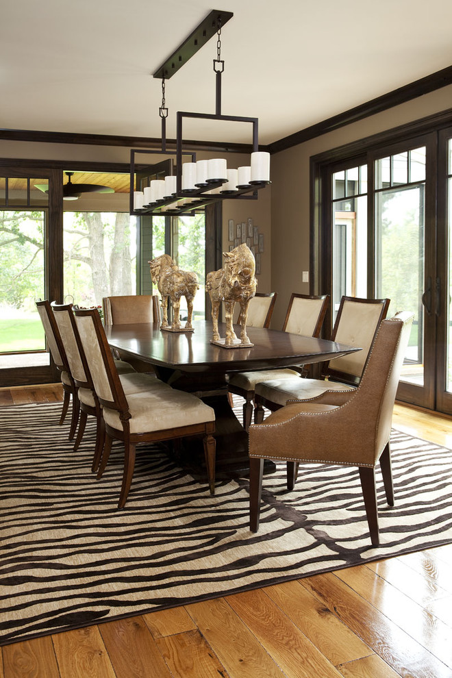 Transitional dining room in Minneapolis with brown walls and medium hardwood floors.