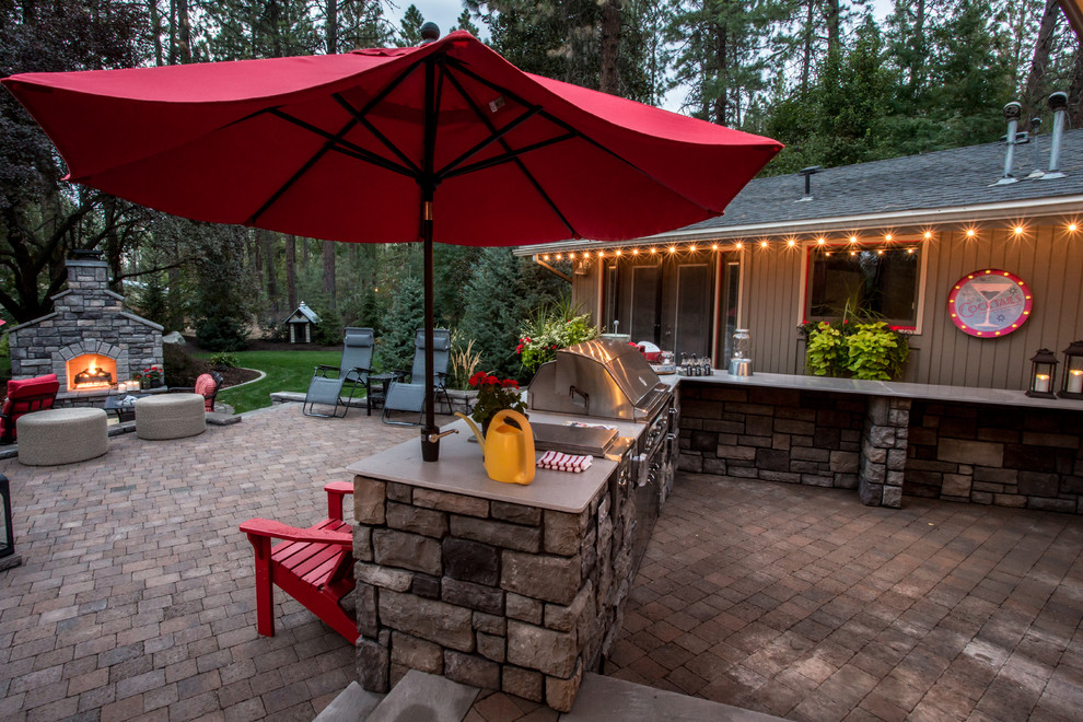 This is an example of a country patio in Seattle with an outdoor kitchen.