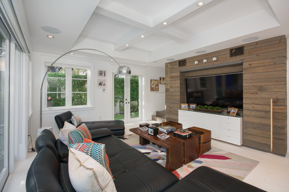Photo of a large contemporary enclosed living room in Miami with white walls, a wall-mounted tv and beige floor.