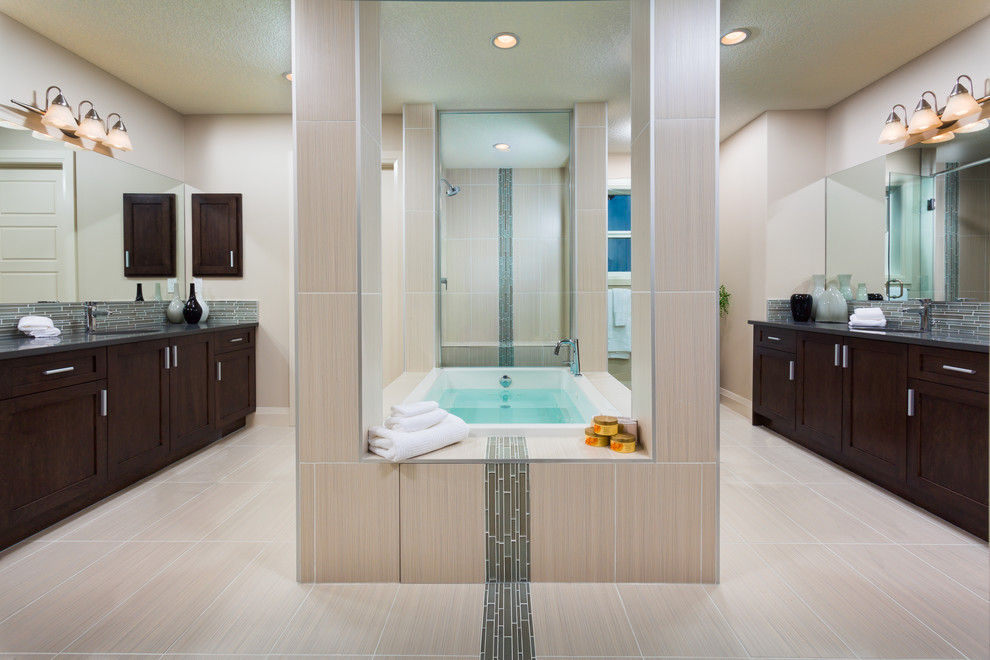 Large contemporary master bathroom in Calgary with shaker cabinets, dark wood cabinets, gray tile, matchstick tile, white walls, an open shower, porcelain floors, an undermount sink and a drop-in tub.