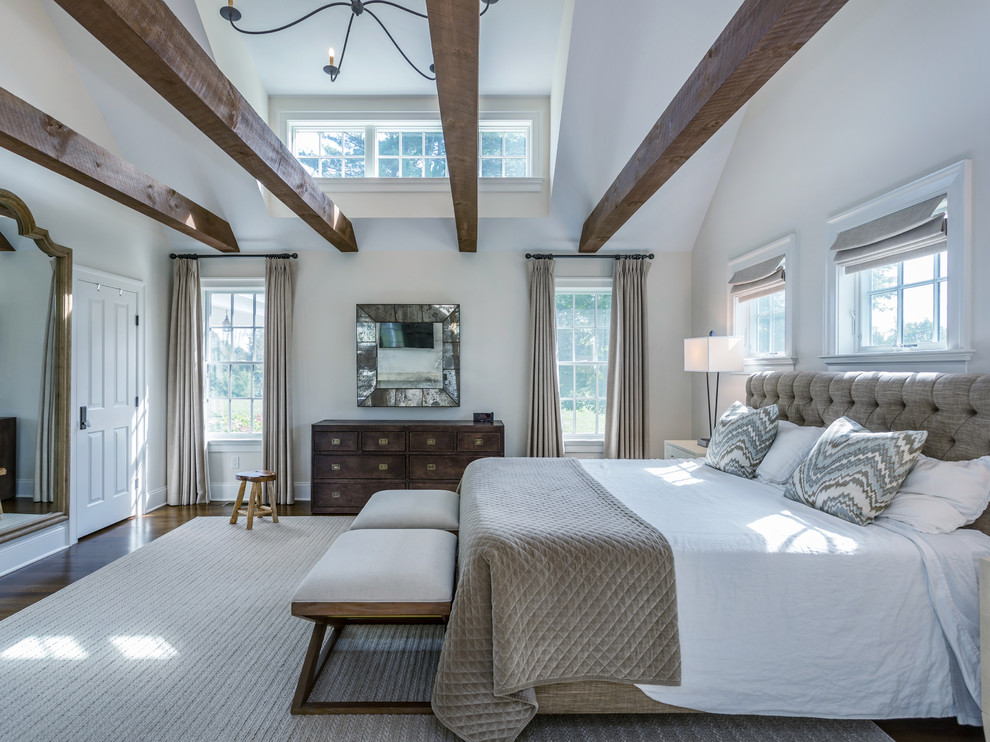Inspiration for a country bedroom in New York with white walls, medium hardwood floors and brown floor.
