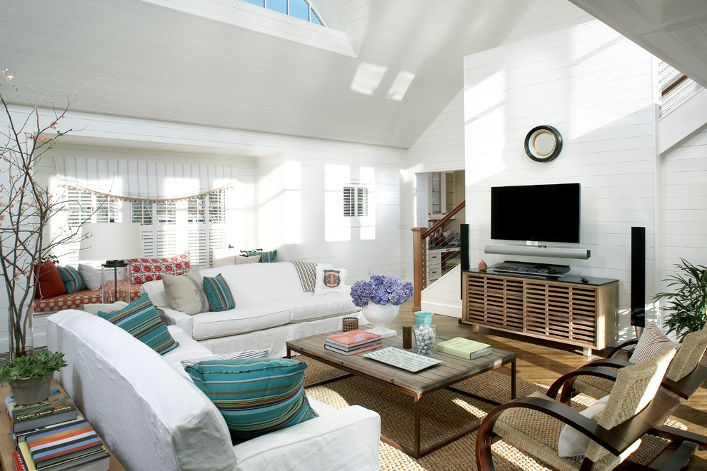 Large beach style open concept living room in Boston with white walls, a wall-mounted tv and medium hardwood floors.