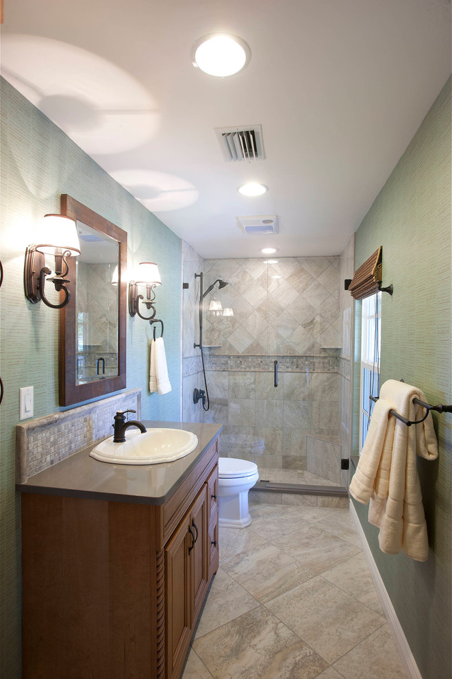 Mid-sized traditional bathroom in Tampa with recessed-panel cabinets, medium wood cabinets, an alcove shower, beige tile, green walls and a drop-in sink.