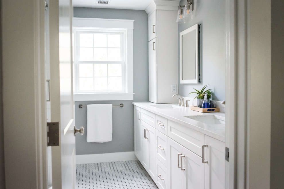 Photo of a mid-sized traditional master bathroom in Boston with shaker cabinets, white cabinets, an open shower, a two-piece toilet, white tile, stone tile, grey walls, mosaic tile floors, an undermount sink, engineered quartz benchtops, white floor, a sliding shower screen and white benchtops.
