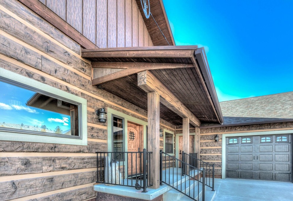 Front door - mid-sized rustic concrete floor and gray floor front door idea with brown walls and a dark wood front door