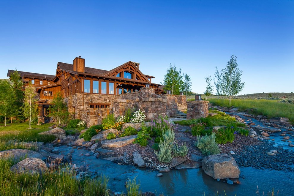 Inspiration for a large rustic full sun backyard stone garden path.