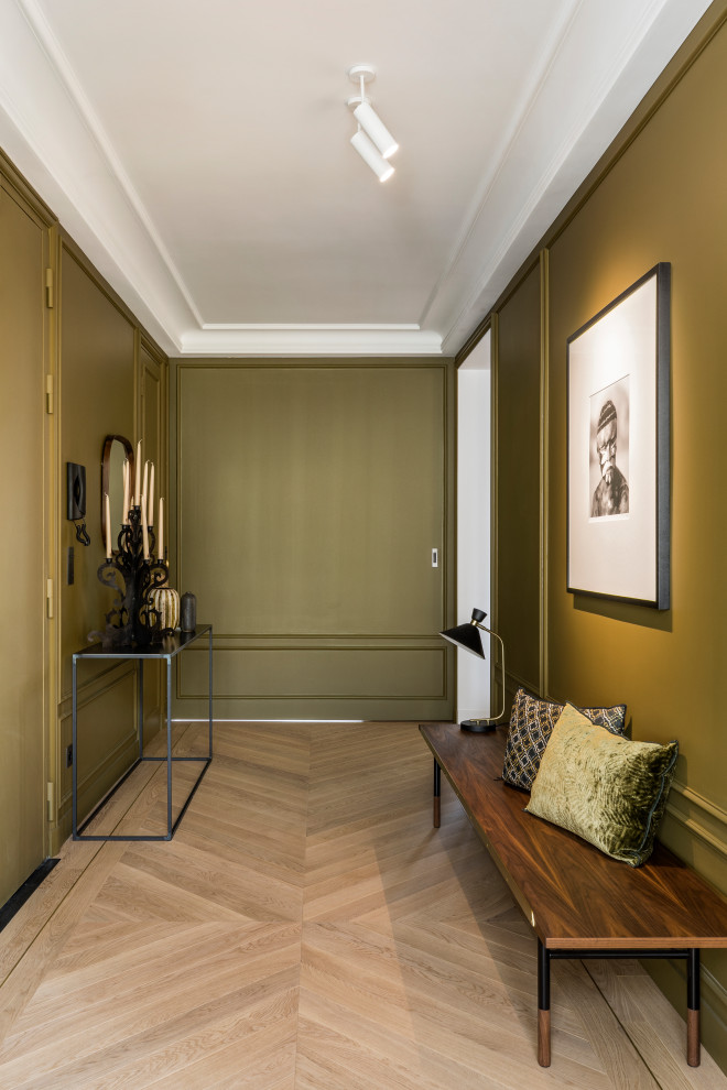 Large contemporary foyer in Paris with green walls, light hardwood floors, a double front door, a green front door, beige floor and decorative wall panelling.