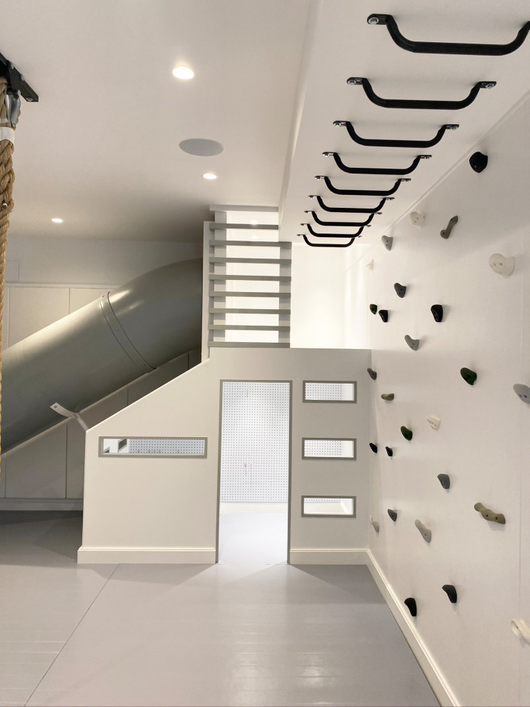 Minimalist perfection! - Playroom - mid-sized country gender-neutral light wood floor, gray floor, wood ceiling and wall paneling playroom idea in New York with white walls