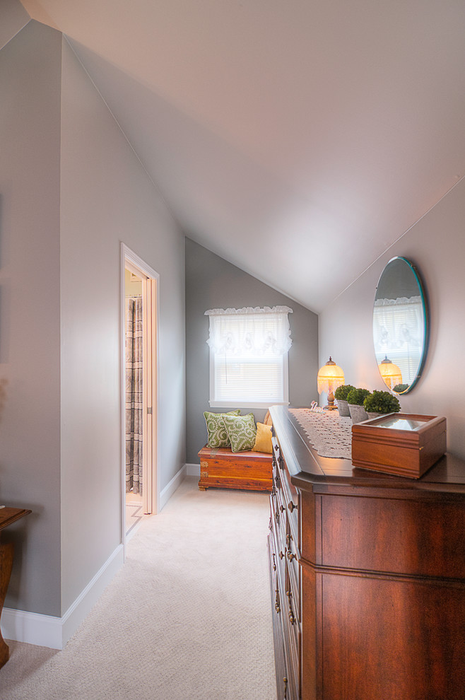 Inspiration for a mid-sized transitional master bedroom with grey walls and carpet.
