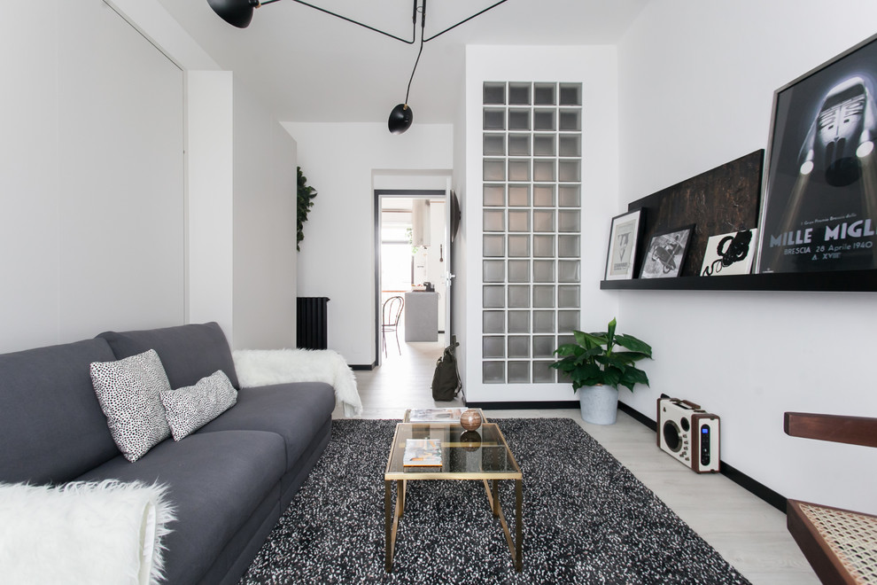 Photo of a scandinavian living room in Melbourne with white walls, light hardwood floors and beige floor.