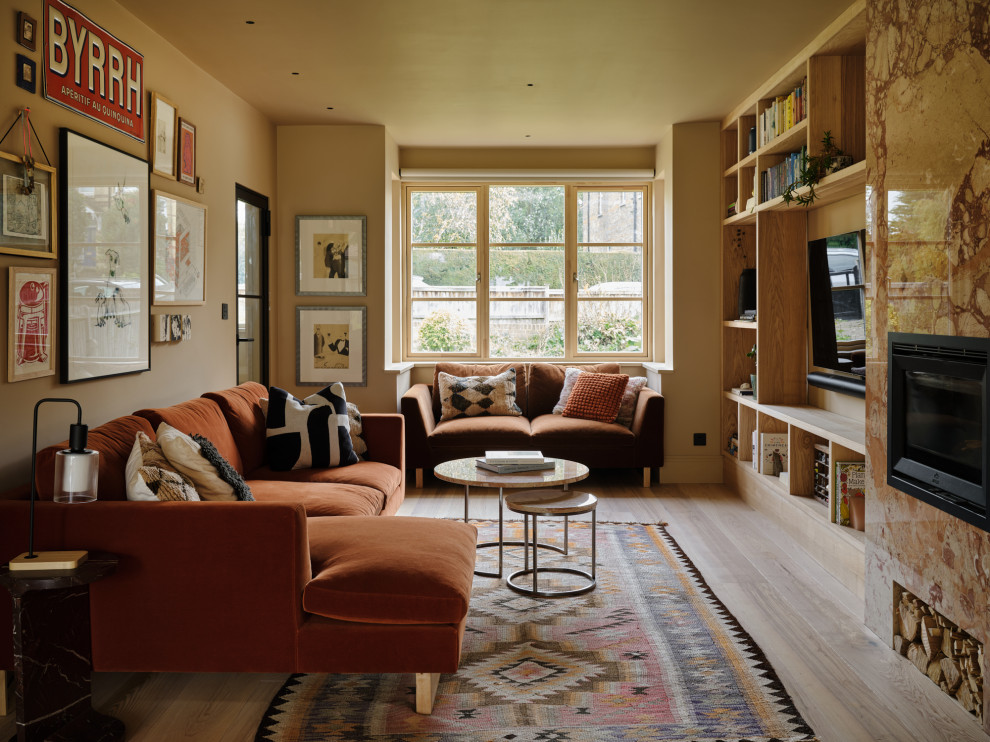 Design ideas for a contemporary enclosed living room in Kent with beige walls, light hardwood flooring, a standard fireplace, a stone fireplace surround, a wall mounted tv and beige floors.